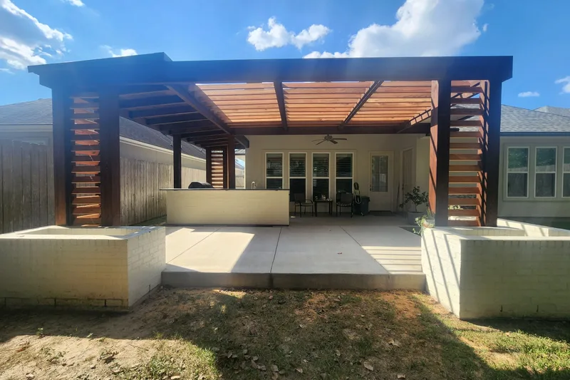 Covered patio addition with a cedar pergola roof over a concrete slab