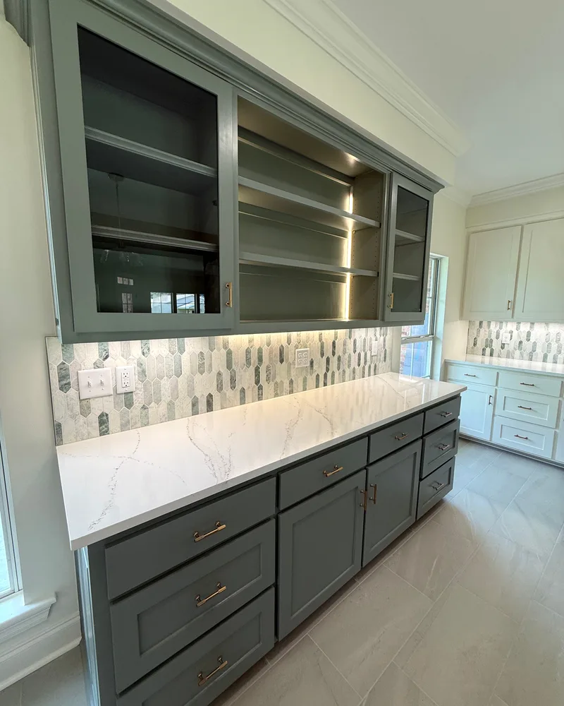 Kitchen remodel, after: gray shaker cabinets, open shelving, a mosaic backsplash and white quartz