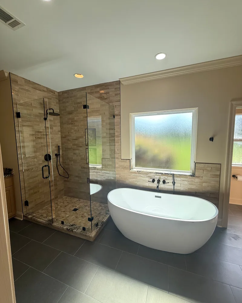 Baton Rouge master bathroom remodel, after: a freestanding soaking tub and a frameless glass walk-in shower